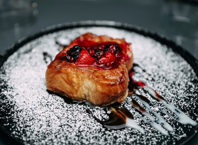 Nutella pizza dessert with berries and powdered sugar