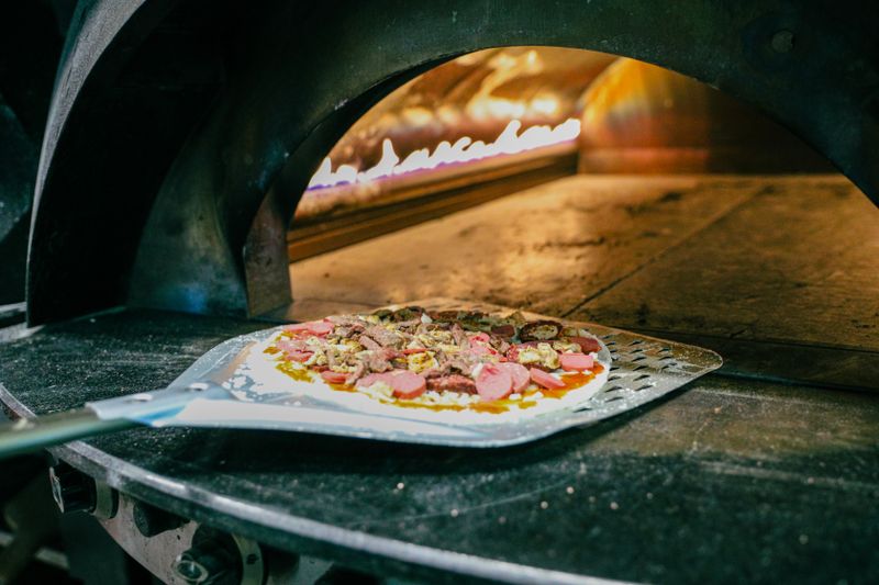 Stone-fired pizza oven at Green Lantern Pizza